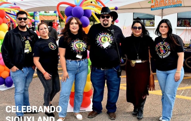 A group of 6 people stand outside a festival